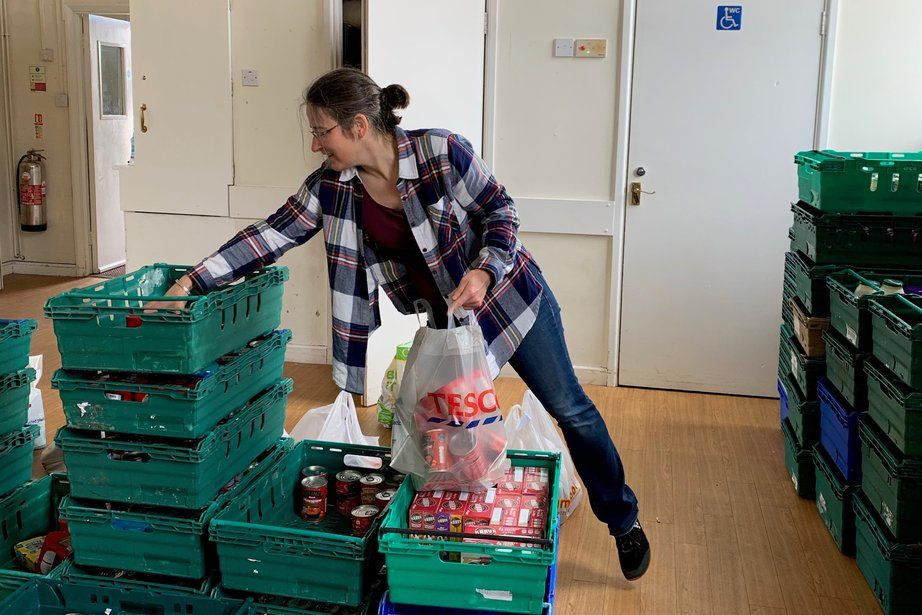 Lady filling crates at food bank