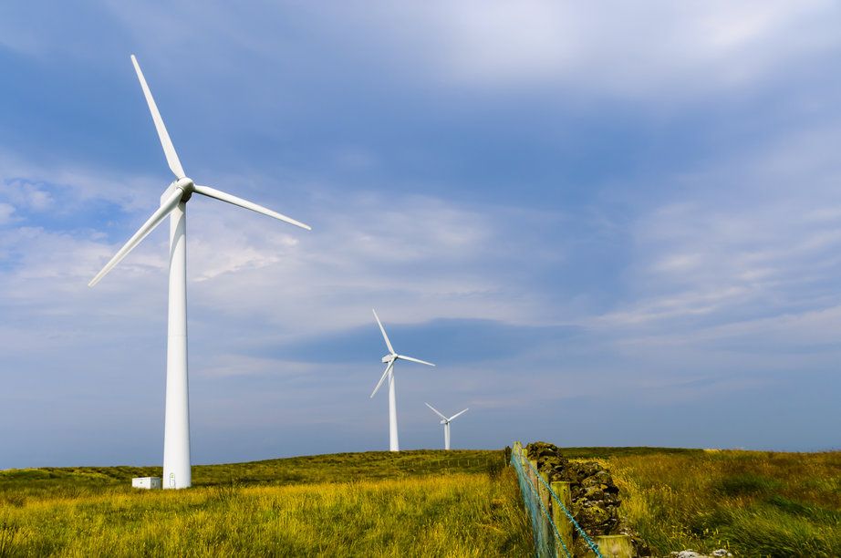 Wind turbines against blue sky