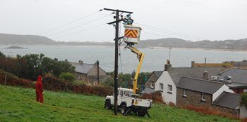 Linesman scaling electricity pole