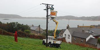 Linesman scaling electricity pole